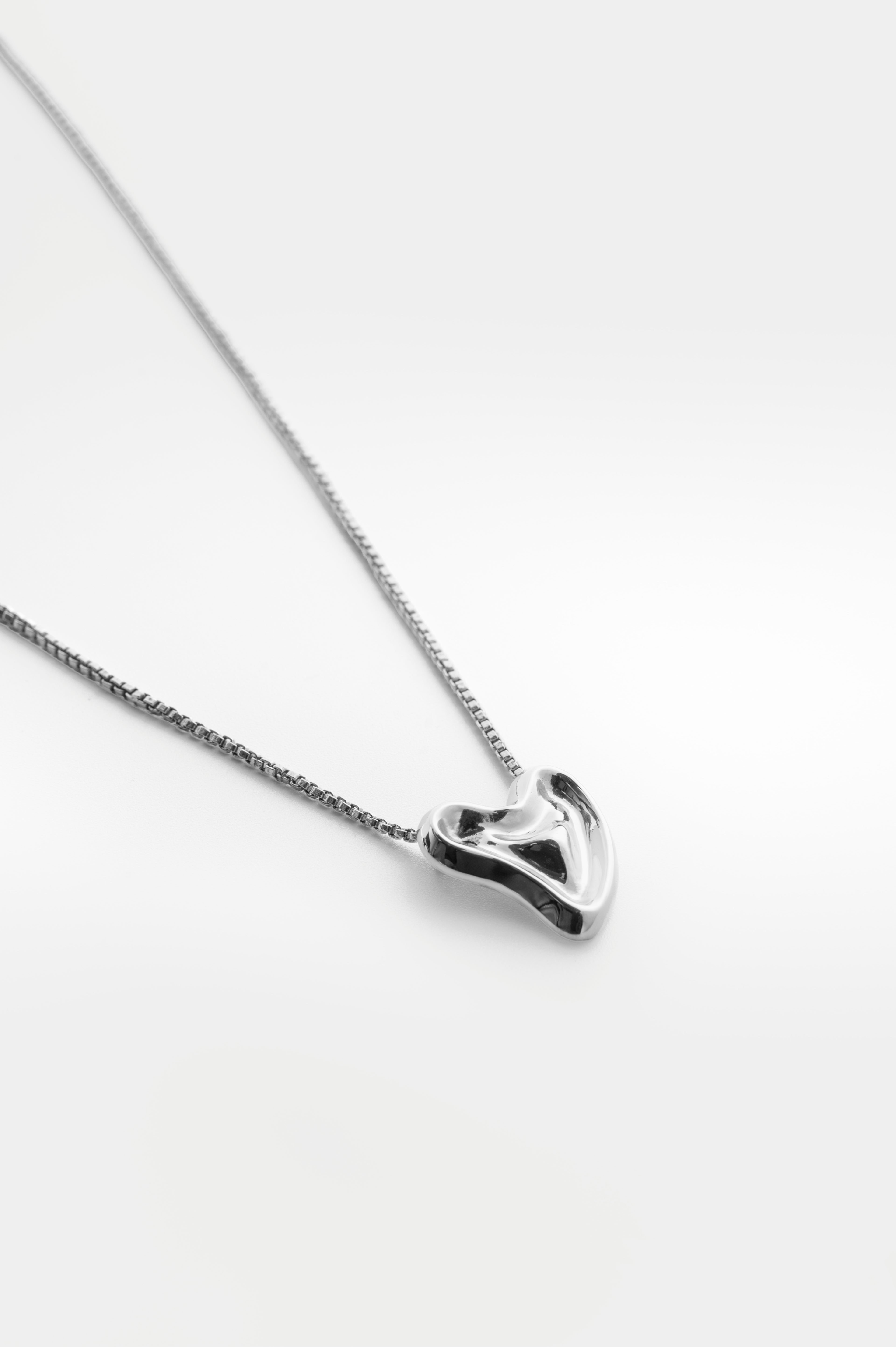 Melted Heart Pendant In Rhodium Plated Brass